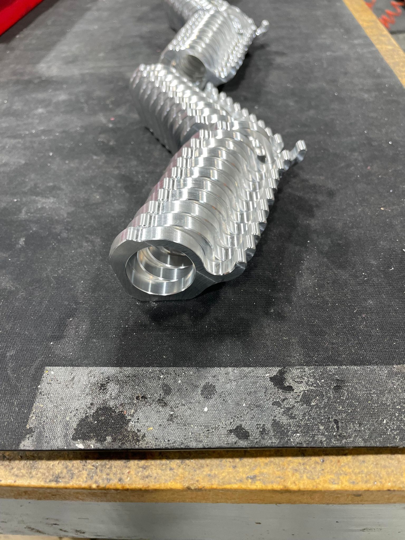 A Large Line of Silver Zero Error Racing Junior Dragster Billet Helmet Hook.